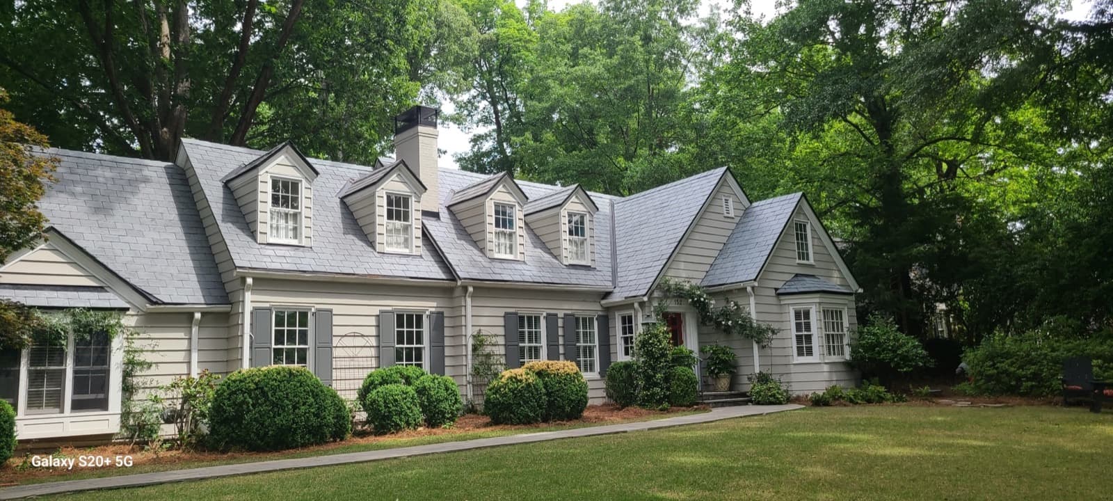 Slate roof installation with dormers and valley transitions on a residential home